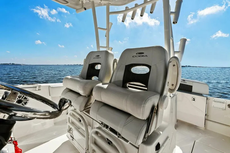  Yacht Photos Pics 2023 Cobia 301 Center Console boat interior with dual captain seats on open water.
