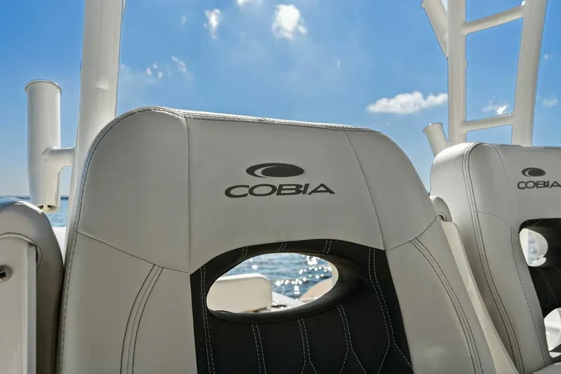  Yacht Photos Pics 2023 Cobia 301 Center Console boat seats under clear blue sky.