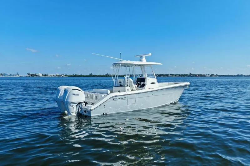  Yacht Photos Pics 2023 Cobia 301 Center Console boat on calm blue water.