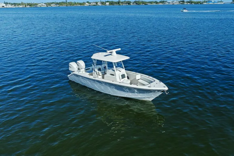  Yacht Photos Pics 2023 Cobia 301 Center Console boat on calm blue water.