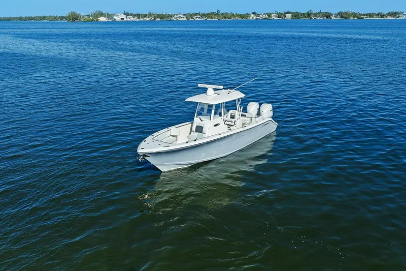  Yacht Photos Pics 2023 Cobia 301 Center Console boat on calm blue water.