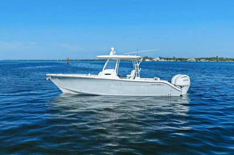  Yacht Photos Pics 2023 Cobia 301 Center Console boat on calm blue water.