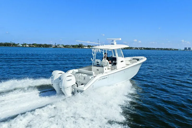  Yacht Photos Pics 2023 Cobia 301 Center Console boat cruising on open water.