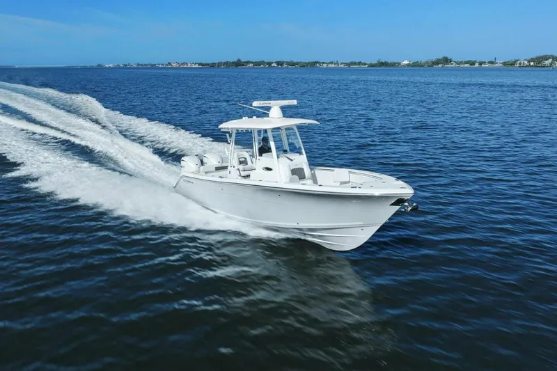  Yacht Photos Pics 2023 Cobia 301 Center Console boat cruising on open water.