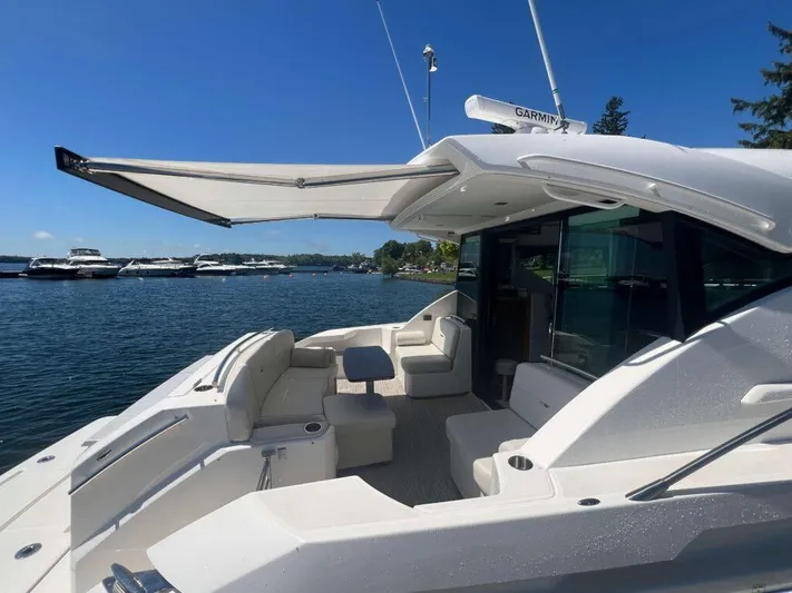  Yacht Photos Pics 2022 Tiara Yachts C44 Coupe on water, featuring spacious deck and modern design.