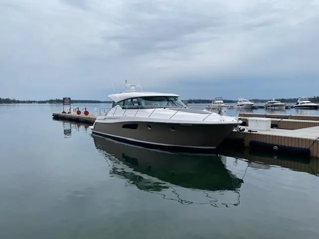  Yacht Photos Pics 2022 Tiara Yachts C44 Coupe docked on a calm, overcast day.