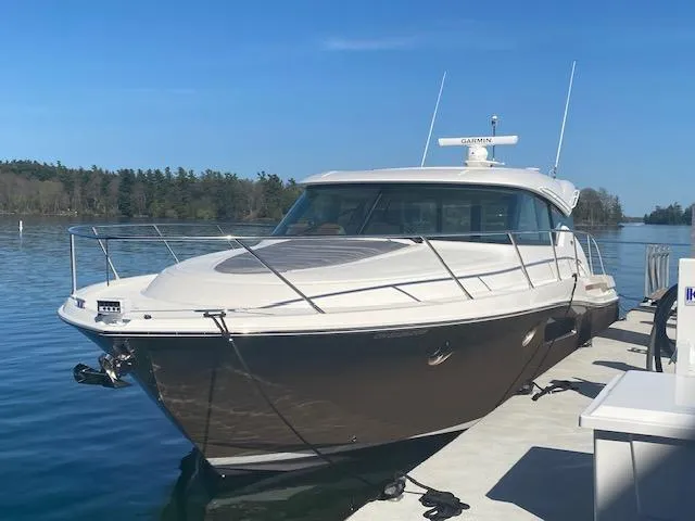  Yacht Photos Pics 2022 Tiara Yachts C44 Coupe docked on a sunny day, showcasing sleek design.
