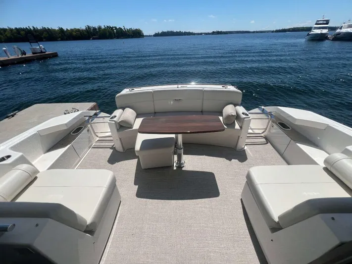  Yacht Photos Pics 2022 Tiara Yachts C44 Coupe deck with seating and table, overlooking serene water.