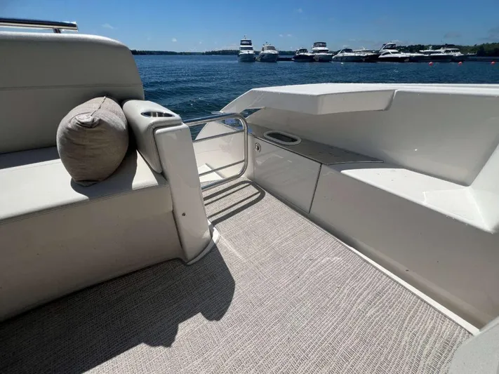  Yacht Photos Pics 2022 Tiara Yachts C44 Coupe deck with seating, overlooking a marina.