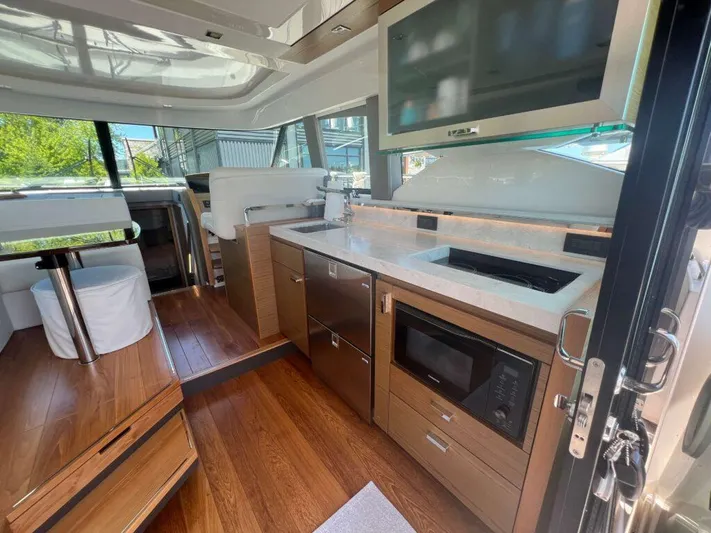 Yacht Photos Pics Interior of 2022 Tiara Yachts C44 Coupe, featuring modern kitchen and seating area.