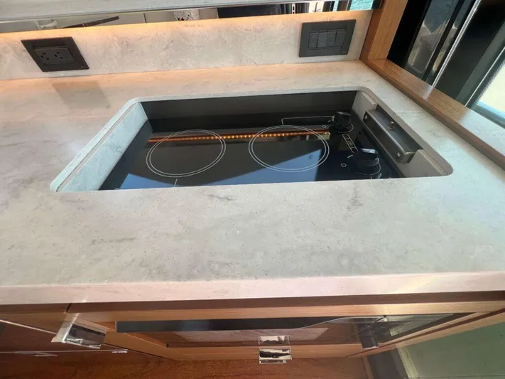  Yacht Photos Pics Modern kitchen area in 2022 Tiara Yachts C44 Coupe with sleek stovetop.