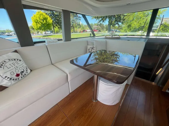  Yacht Photos Pics Luxurious interior of 2022 Tiara Yachts C44 Coupe with elegant seating and table.