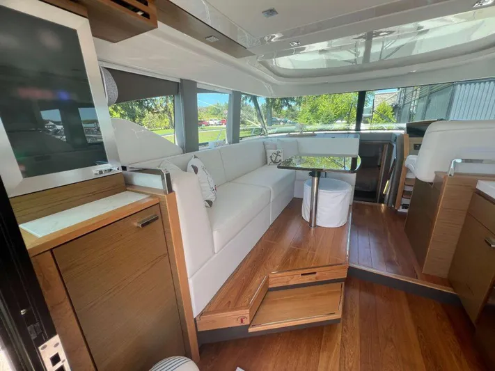  Yacht Photos Pics Interior of 2022 Tiara Yachts C44 Coupe with modern seating and wooden flooring.