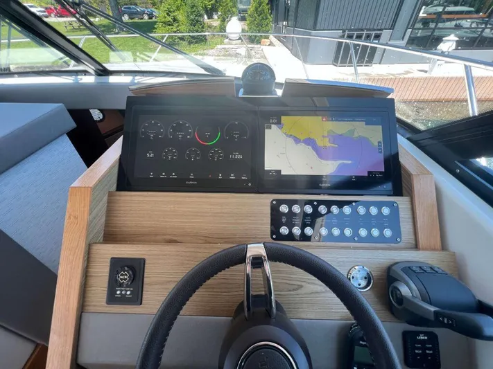  Yacht Photos Pics Helm of 2022 Tiara Yachts C44 Coupe with navigation screens and controls.