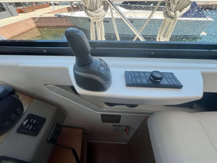  Yacht Photos Pics Control panel of 2022 Tiara Yachts C44 Coupe with joystick and buttons.