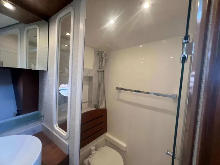  Yacht Photos Pics Bathroom interior of 2022 Tiara Yachts C44 Coupe, featuring modern fixtures and sleek design.