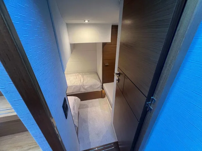  Yacht Photos Pics 2022 Tiara Yachts C44 Coupe cabin interior with modern design and cozy sleeping area.