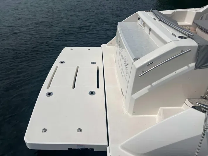  Yacht Photos Pics 2022 Tiara Yachts C44 Coupe swim platform on calm water.