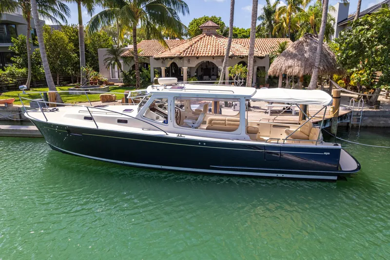 Euphony Yacht Photos Pics 2013 MJM 36z Downeast boat docked by a tropical waterfront home.