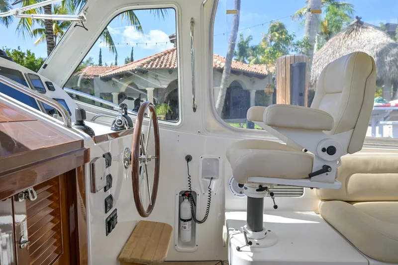 Euphony Yacht Photos Pics Interior of 2013 MJM 36z Downeast boat with steering wheel and captain's chair.