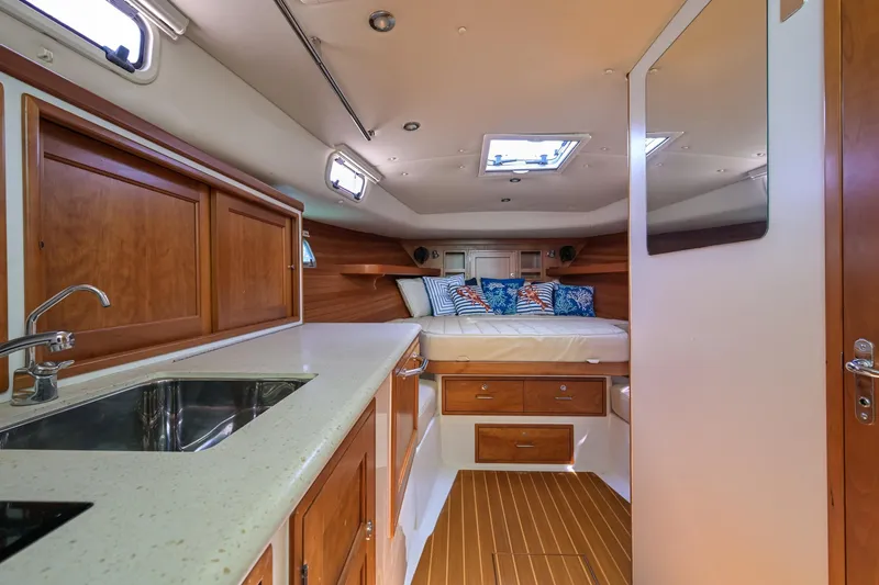 Euphony Yacht Photos Pics 2013 MJM 36z Downeast yacht interior with cozy cabin, bed, and kitchenette.