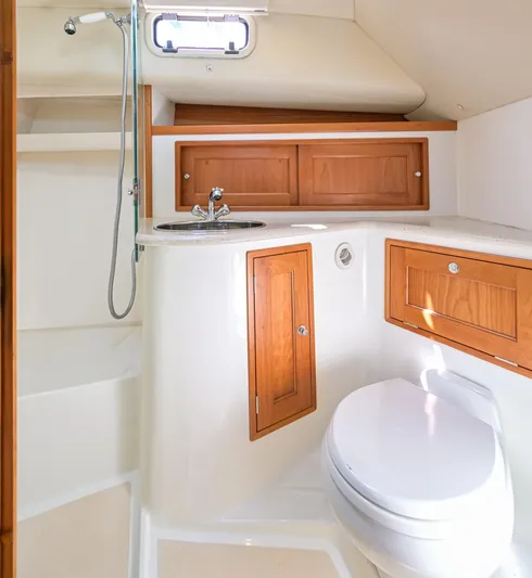 Euphony Yacht Photos Pics 2013 MJM 36z Downeast yacht bathroom with wooden cabinets and modern fixtures.