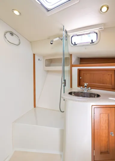 Euphony Yacht Photos Pics 2013 MJM 36z Downeast yacht bathroom with shower, sink, and wooden cabinetry.