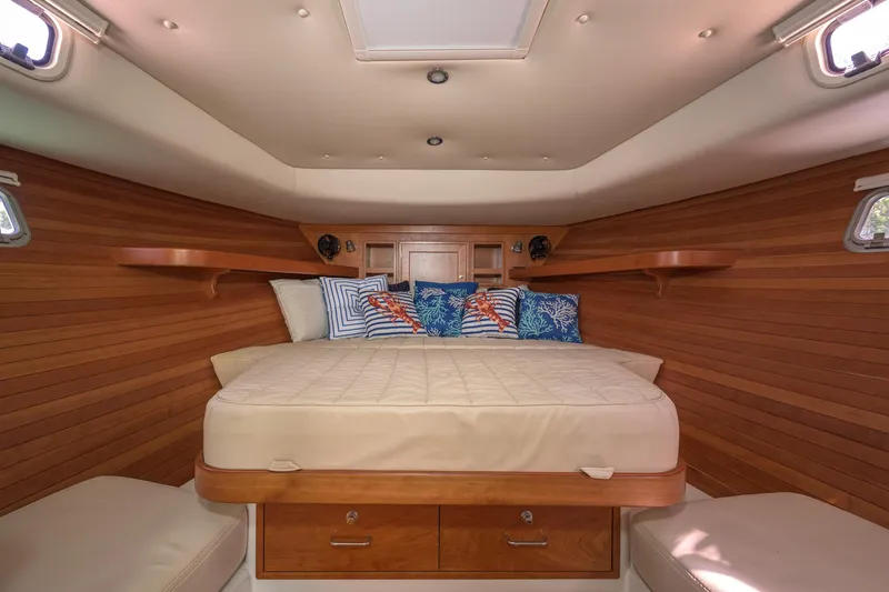 Euphony Yacht Photos Pics Luxurious cabin interior of 2013 MJM 36z Downeast boat with cozy bed and wooden finish.