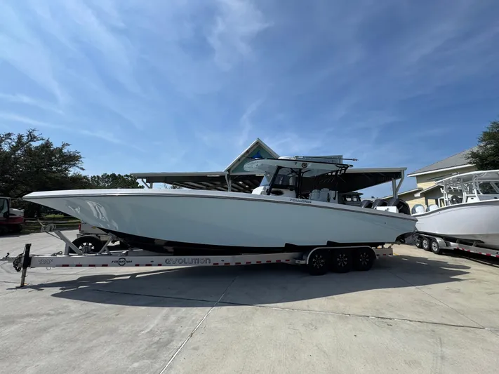 Yacht Photos Pics 2022 Fountain 38TE boat on trailer under clear blue sky.