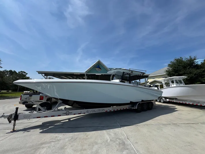  Yacht Photos Pics 2022 Fountain 38TE boat on trailer, parked outdoors under clear blue sky.