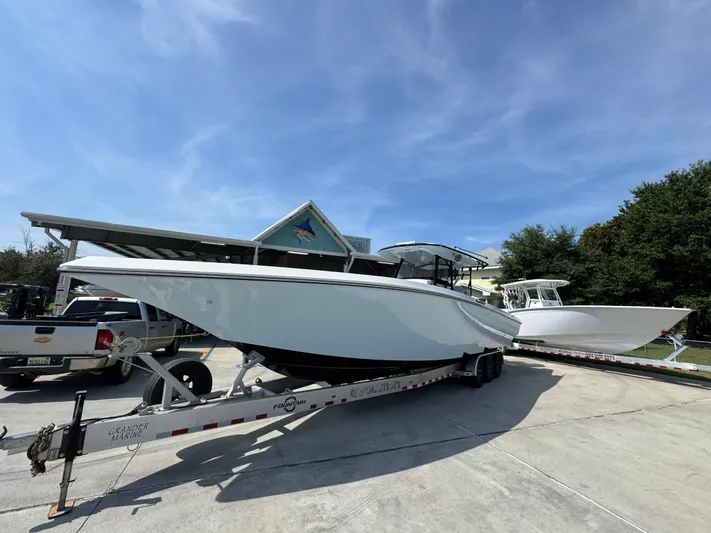  Yacht Photos Pics 2022 Fountain 38TE boat on trailer under clear blue sky.