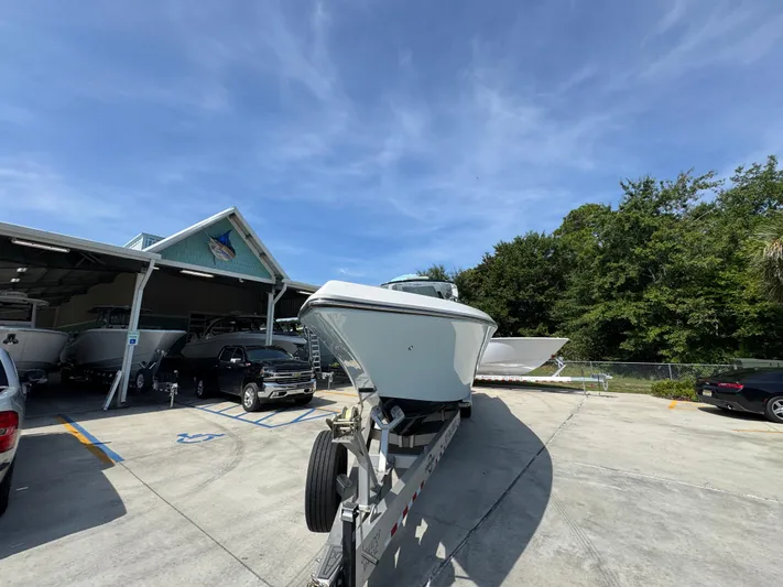  Yacht Photos Pics 2022 Fountain 38TE boat on trailer at dealership under clear blue sky.