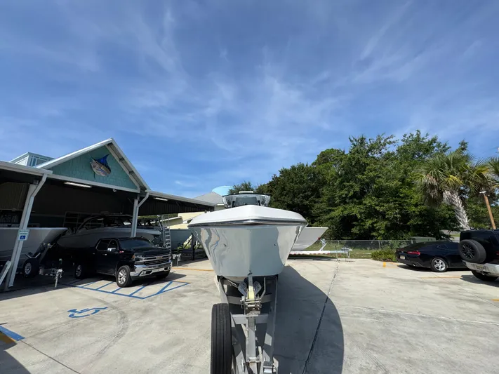  Yacht Photos Pics 2022 Fountain 38TE boat on trailer in parking lot under clear blue sky.