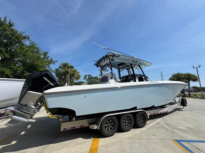  Yacht Photos Pics 2022 Fountain 38TE boat on trailer, parked outdoors under clear blue sky.