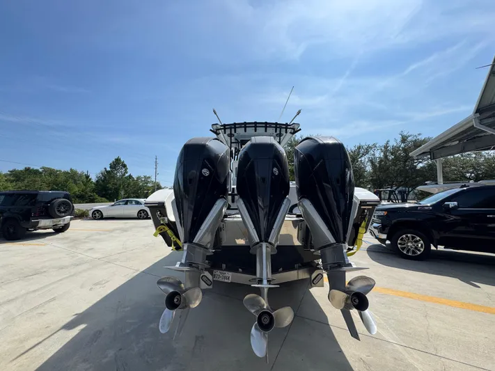  Yacht Photos Pics 2022 Fountain 38TE boat with four powerful outboard engines in a parking lot.