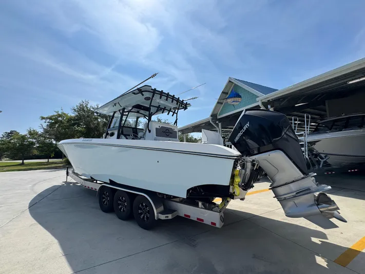  Yacht Photos Pics 2022 Fountain 38TE boat on trailer, parked outdoors under clear blue sky.
