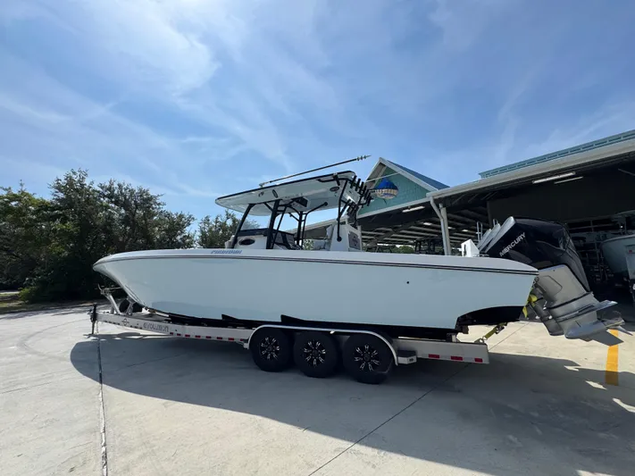  Yacht Photos Pics 2022 Fountain 38TE boat on trailer, parked outdoors under clear sky.