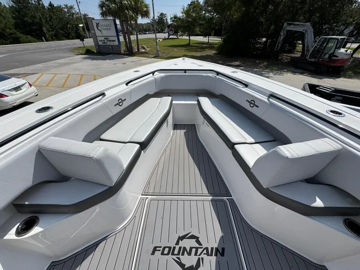  Yacht Photos Pics 2022 Fountain 38TE boat interior with cushioned seating and branded flooring.