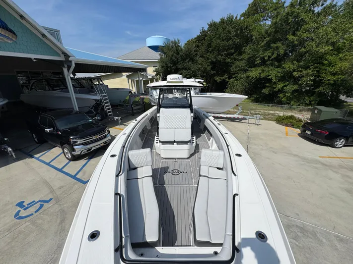  Yacht Photos Pics 2022 Fountain 38TE boat docked, showcasing sleek design and spacious deck layout.