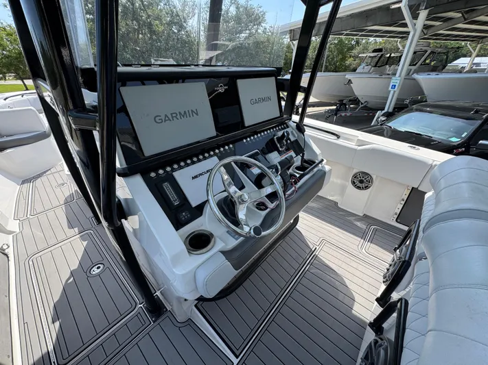  Yacht Photos Pics 2022 Fountain 38TE boat cockpit with Garmin displays and Mercury controls.