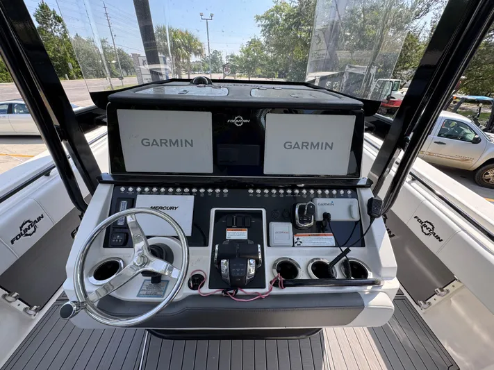  Yacht Photos Pics 2022 Fountain 38TE boat dashboard with Garmin navigation and Mercury controls.