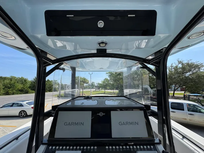  Yacht Photos Pics 2022 Fountain 38TE boat dashboard with dual Garmin displays and control panel.
