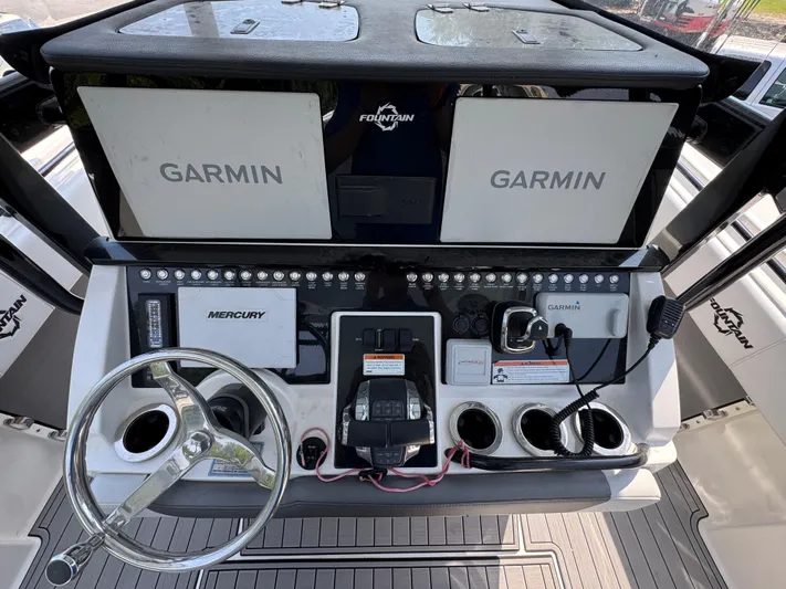  Yacht Photos Pics 2022 Fountain 38TE boat dashboard with Garmin displays and Mercury controls.