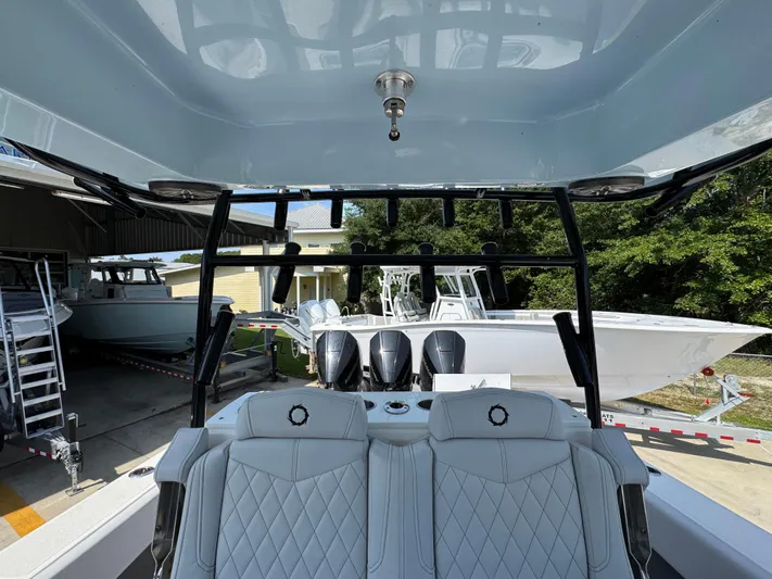  Yacht Photos Pics 2022 Fountain 38TE boat interior with luxurious seating and multiple outboard engines.