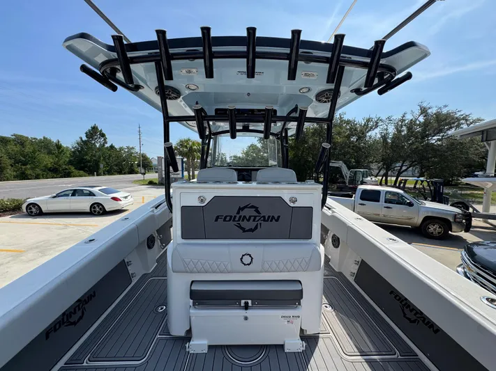  Yacht Photos Pics 2022 Fountain 38TE boat interior with seating and storage, parked in a lot.