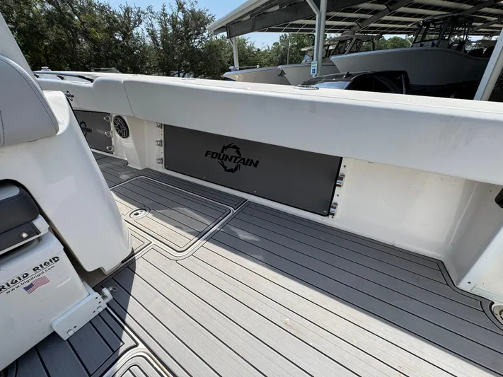  Yacht Photos Pics 2022 Fountain 38TE boat interior with sleek deck and branded panel.