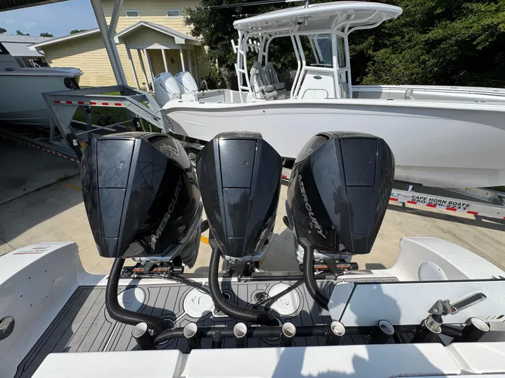  Yacht Photos Pics Triple Mercury outboard engines on a 2022 Fountain 38TE boat, parked on a trailer.