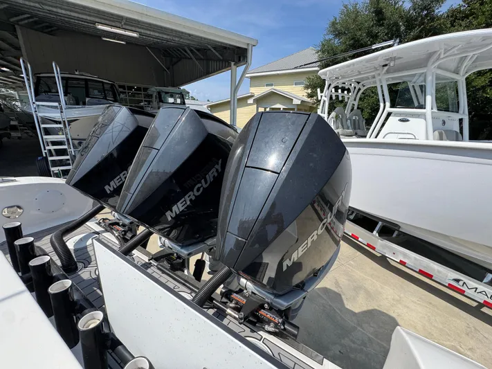  Yacht Photos Pics Triple Mercury outboard engines on a 2022 Fountain 38TE boat, docked outdoors.