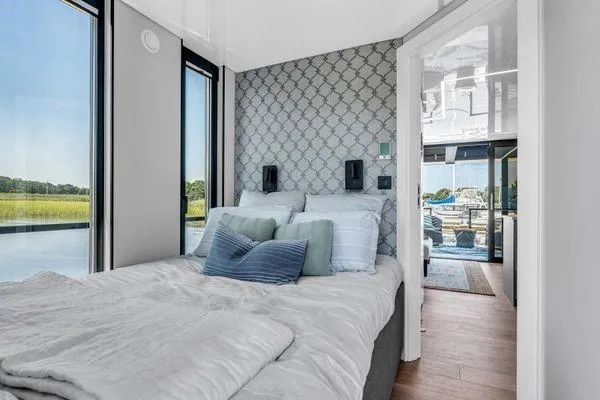  Yacht Photos Pics Modern bedroom in La Mare Modern 11 houseboat, 2024 model, with scenic water views.
