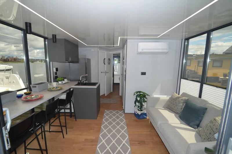  Yacht Photos Pics Modern La Mare houseboat interior with sleek kitchen, cozy living area, and stylish decor, 2024 model.